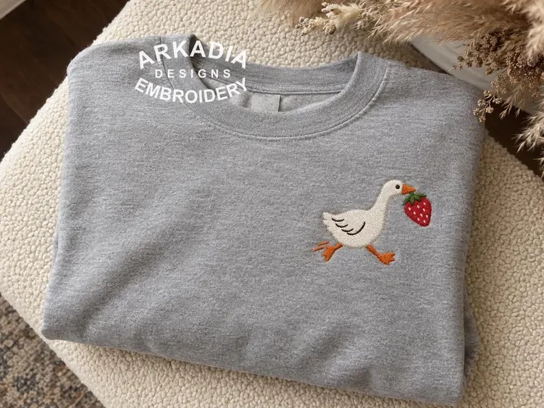 Small goose embroidered on a gray sweatshirt